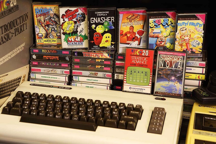A collection of vintage video game cartridges and a keyboard. 3