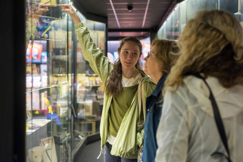 A person taking a photo with a smartphone in a store. 2