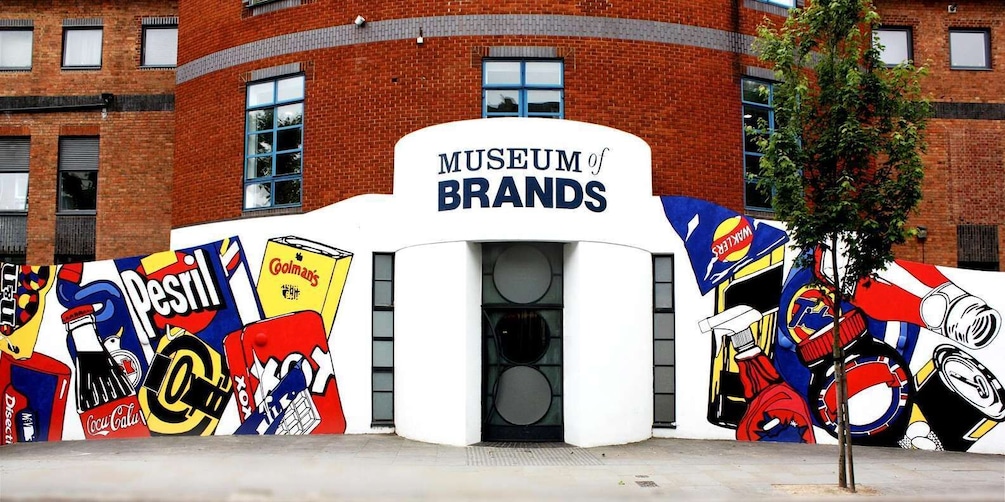 A building with a sign reading "Museum of Brands" and colorful brand murals on its facade. 1