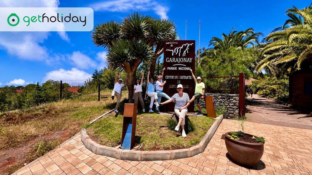 A group of people posing in front of a sign for Garajonay National Park. 4