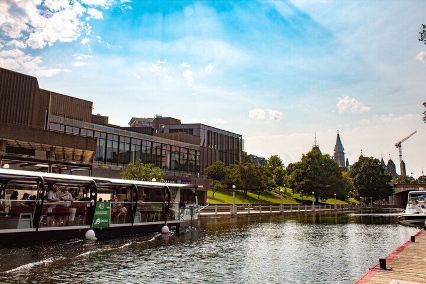 A river with boats, a bridge, and modern buildings in the background. 5