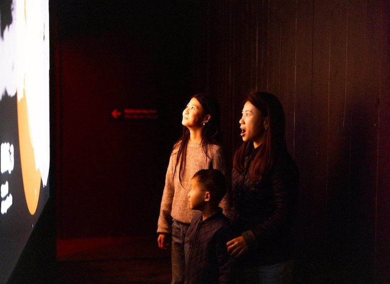 Two people standing in front of a projection screen with a red arrow pointing left. 5