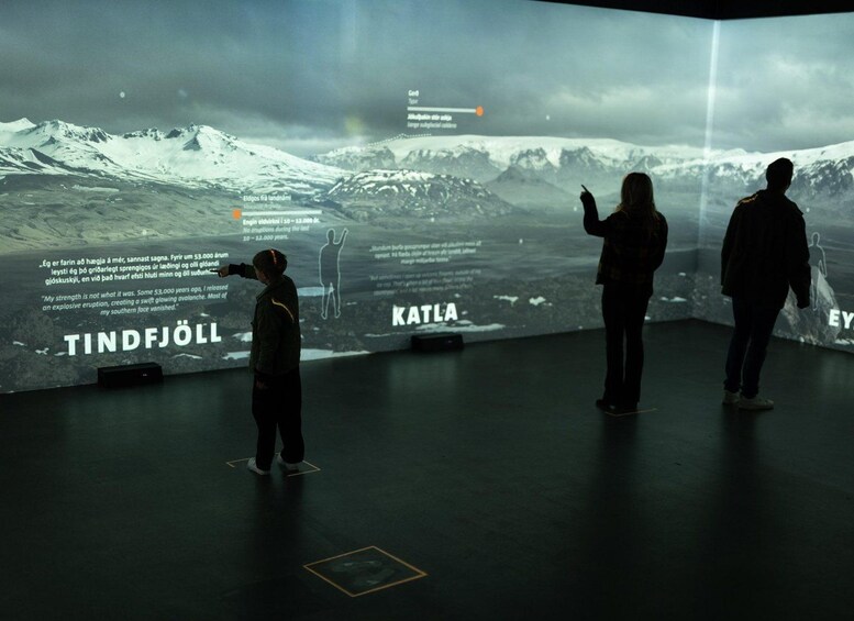 A large digital display with a snowy mountain landscape, text, and silhouettes of people. 4