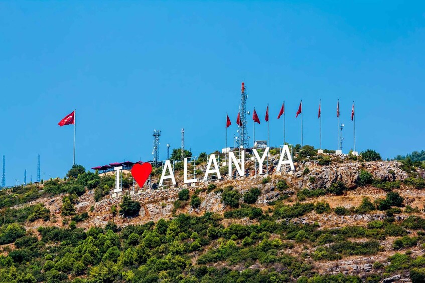 A mountainous landscape with the word "ALANYA" spelled out in large letters. 5