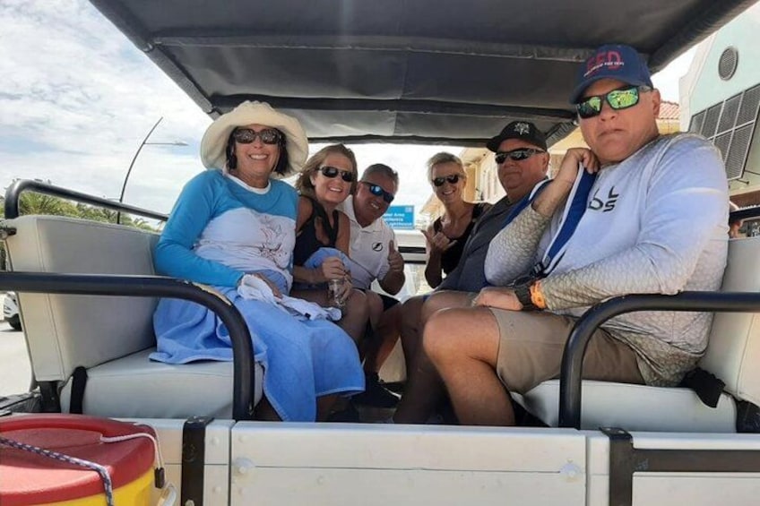 A group of people seated on a boat. 3