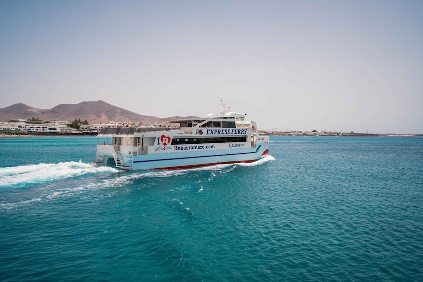 A ferry named 'EXPRESS FERRY' moving through turquoise waters with a mountainous landscape in the background. 5
