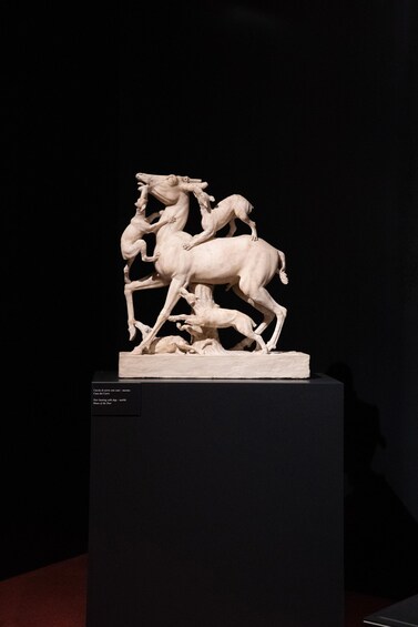 A marble sculpture of a dynamic battle scene with multiple figures and horses. 4
