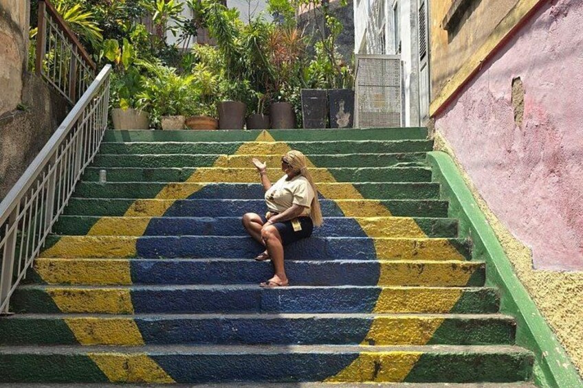 A person sitting on a staircase with a colorful pattern. 4
