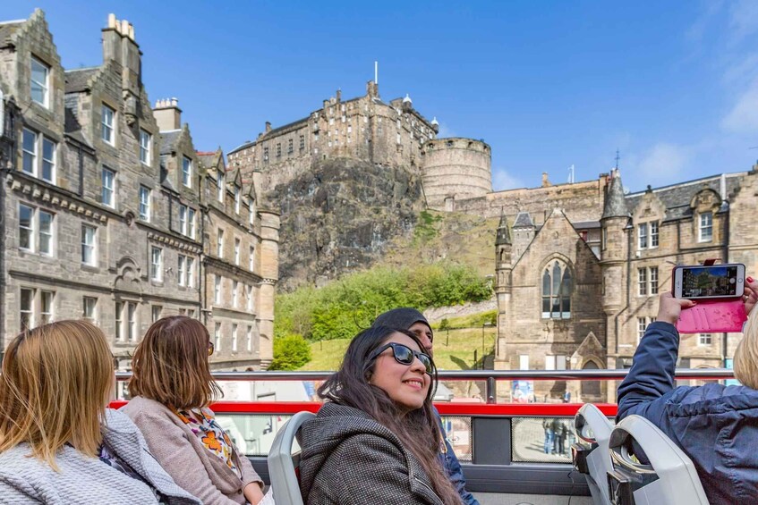 Tourists on a sightseeing bus overlooking a historic castle. 5