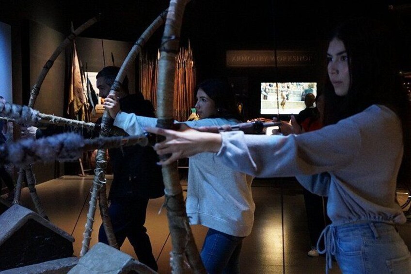 A person pulling a large wooden structure. 2