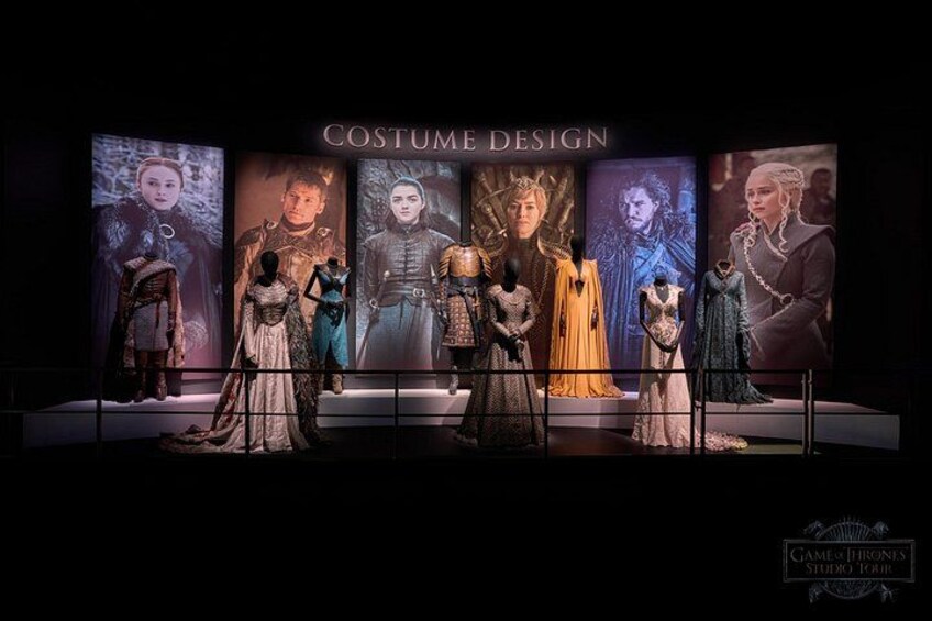 A costume design exhibit with mannequins dressed in elaborate outfits. 2