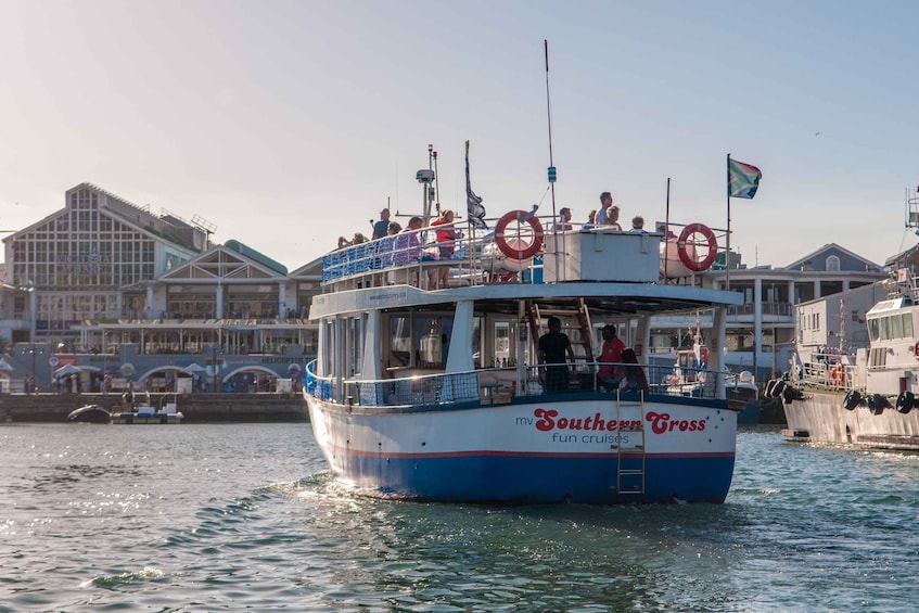 A boat named 'Southern Cross' with lifebuoys and passengers on board. 5