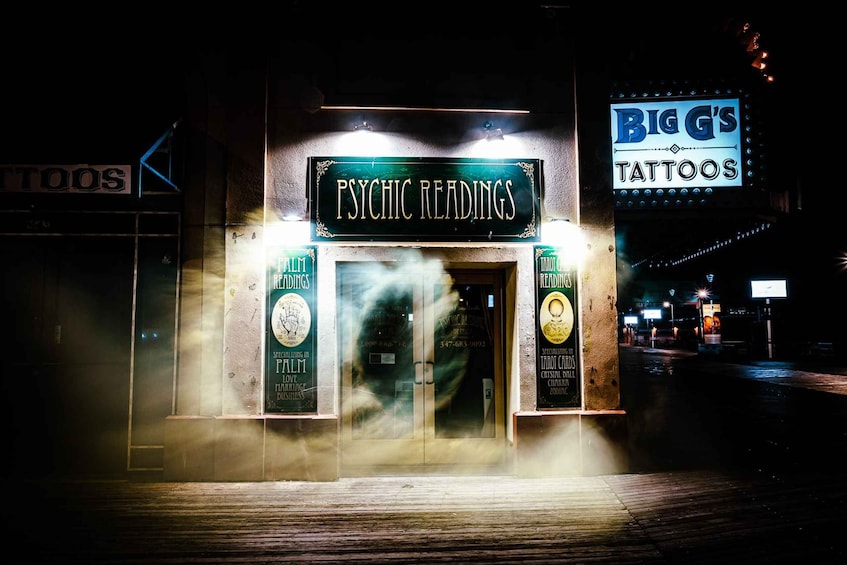 A storefront with a sign reading 'PSYCHIC READINGS' and another sign for 'BIG'S TATTOOS' in the background. 5