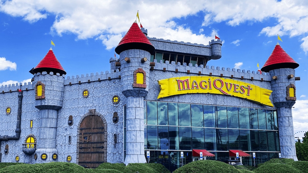 A castle-like building with a yellow sign reading 'MAGIQWEST.' 3