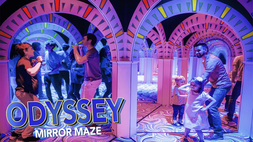 A colorful maze with arches and people walking through it. 4