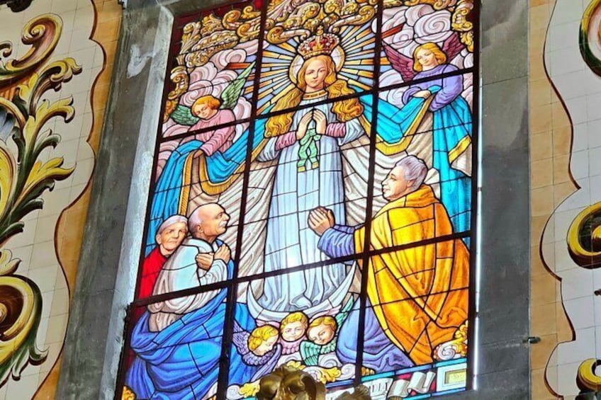A stained glass window with religious figures and intricate patterns. 5