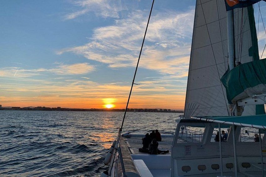 A sailboat on calm waters during sunset with a clear sky. 5