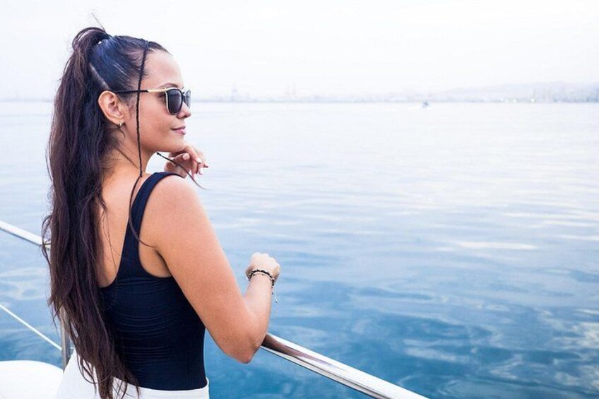 A person on a boat with a view of a calm body of water and a distant shoreline. 4