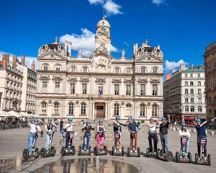 A group of people on segways in front of a historic building with a clock tower. 5