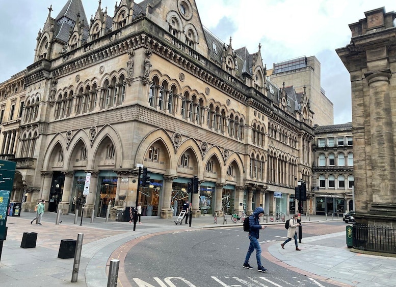 A historic building with ornate architecture, a pedestrian crossing, and a Starbucks coffee shop. 4