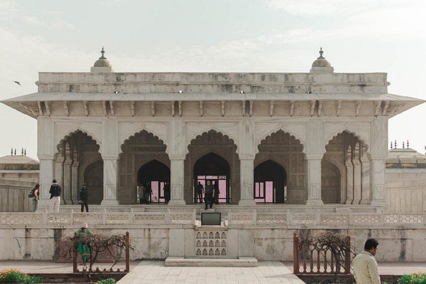 A historical building with arched doorways and intricate carvings. 3