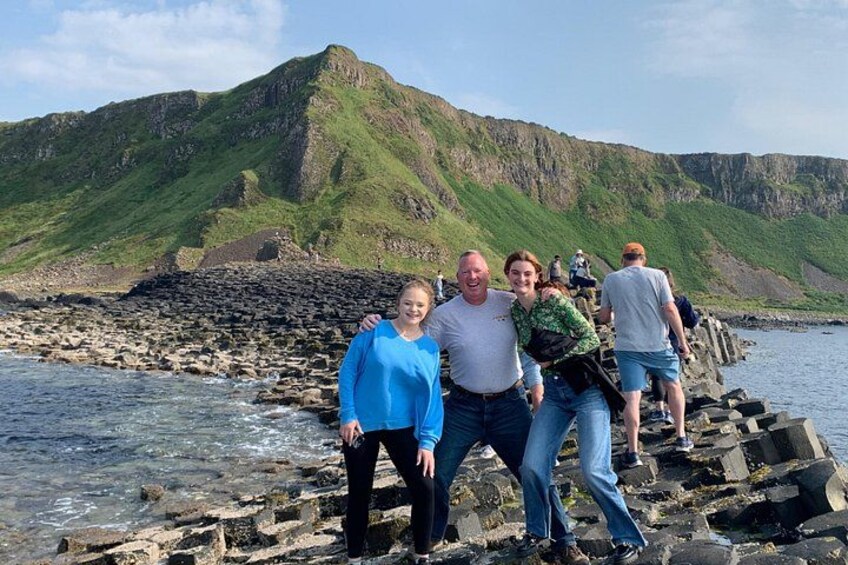 A rocky coastline with people walking along the path. 3