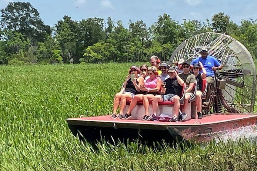 A group of people on a boat in a grassy field. 3