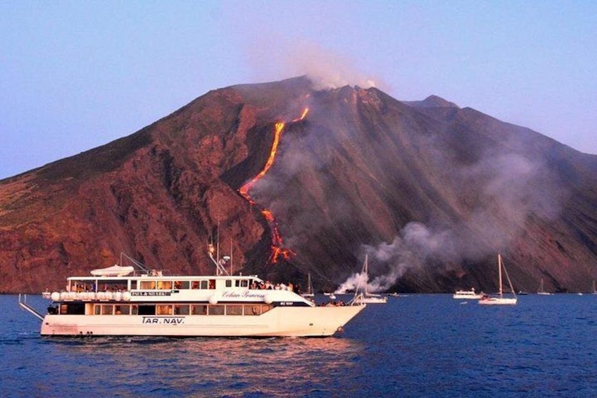 A boat named 'JAR. NAV.' with a volcanic mountain in the background. 4