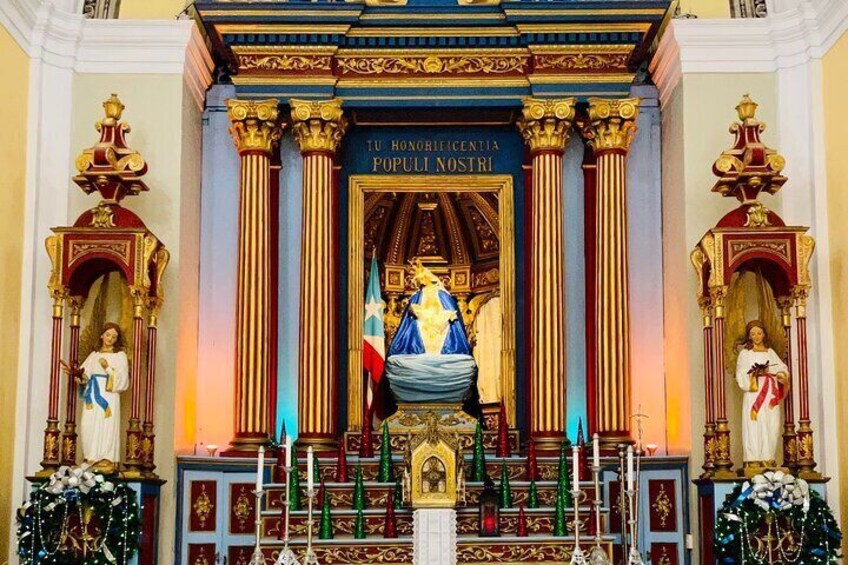 A religious altar with a central statue, flanked by ornate columns and religious icons. 4