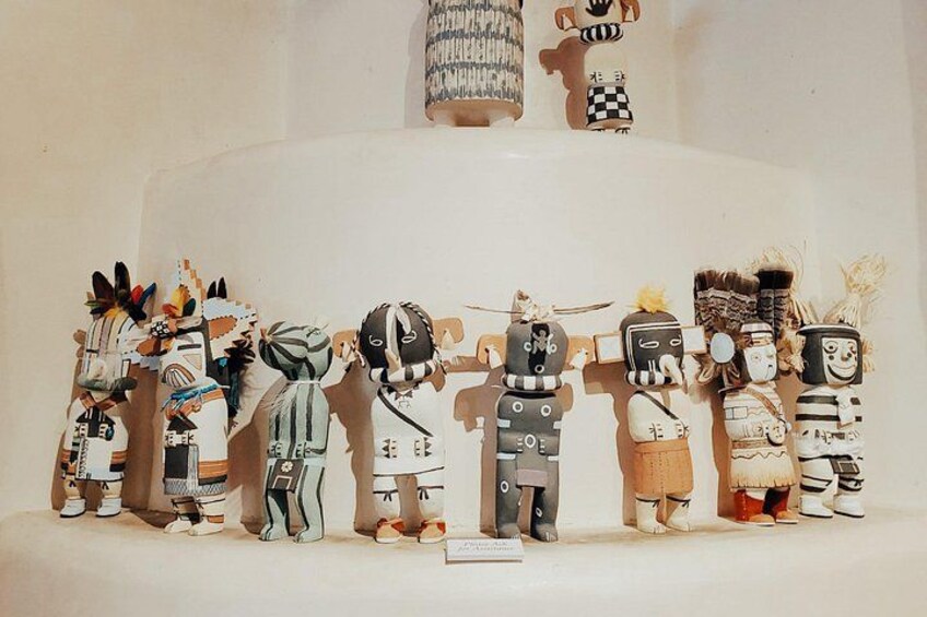 A collection of traditional Native American dolls with intricate designs and accessories. 5