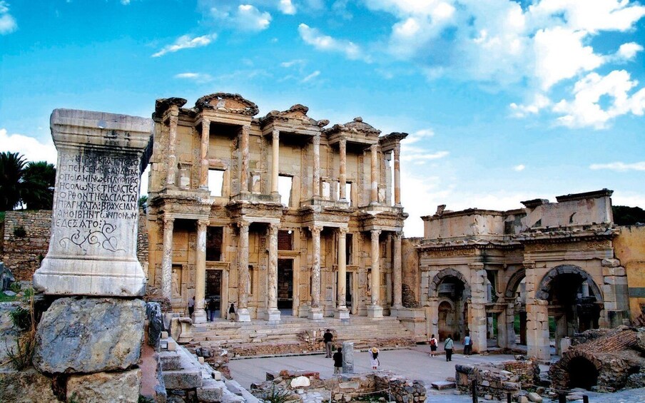 Ancient ruins with columns and a stone inscription. 1