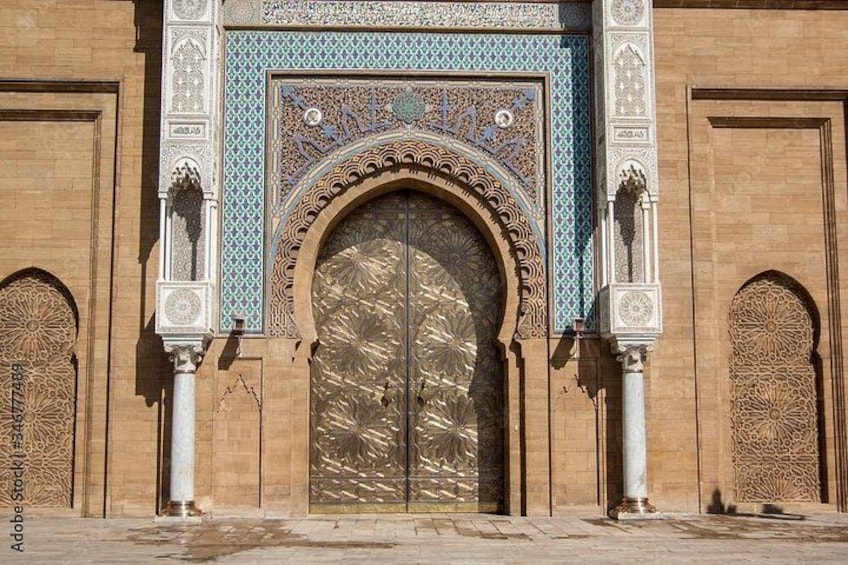 A large ornate door with intricate patterns and a large archway. 2