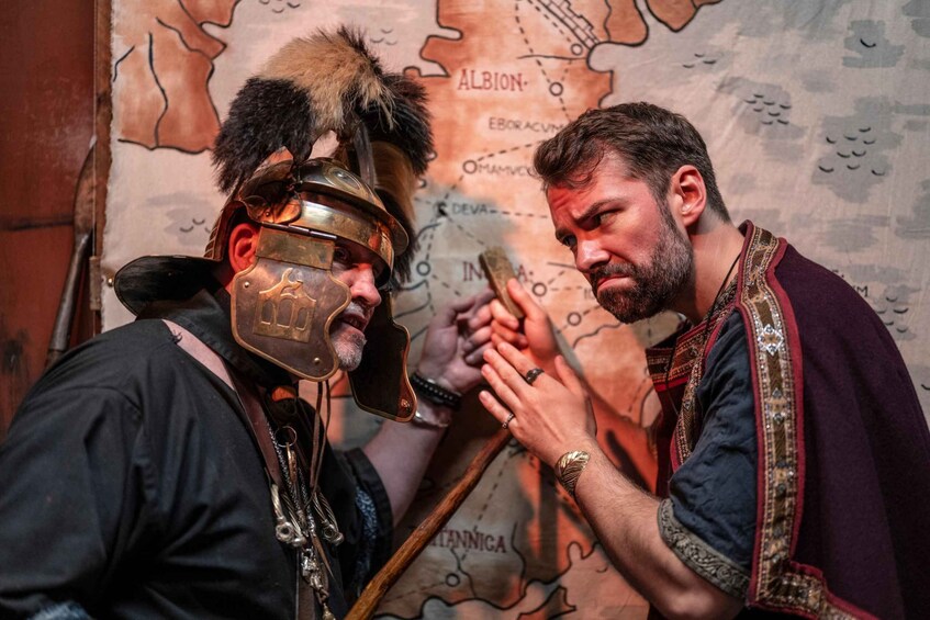 A person in a helmet with a fur plume and a sword, standing in front of a map with the word 'ALBION' visible. 1