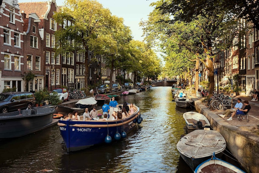 A canal lined with traditional buildings, a boat with people, and parked bicycles. 5
