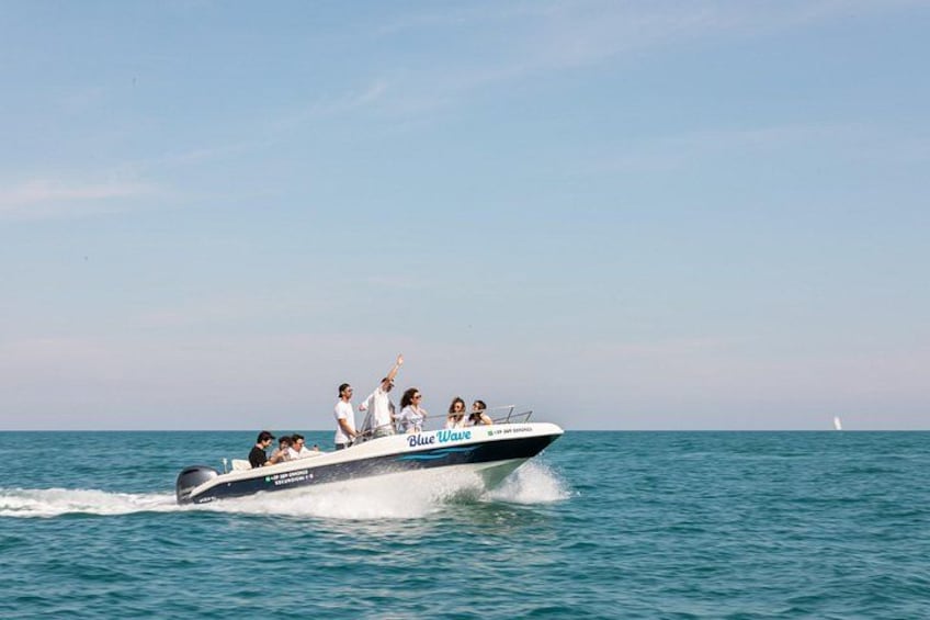 A speedboat with passengers, moving on a calm sea. 3