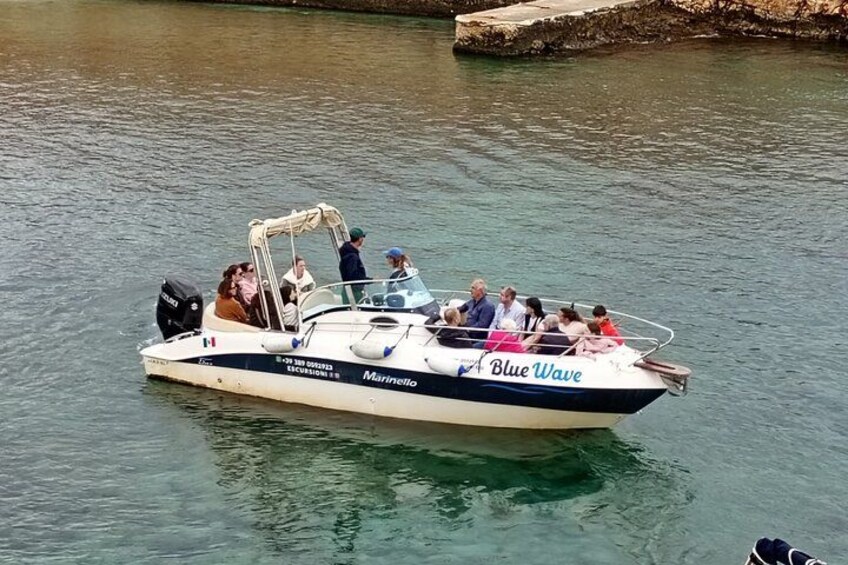 A boat named 'Blue Wave' with passengers on a calm river. 3