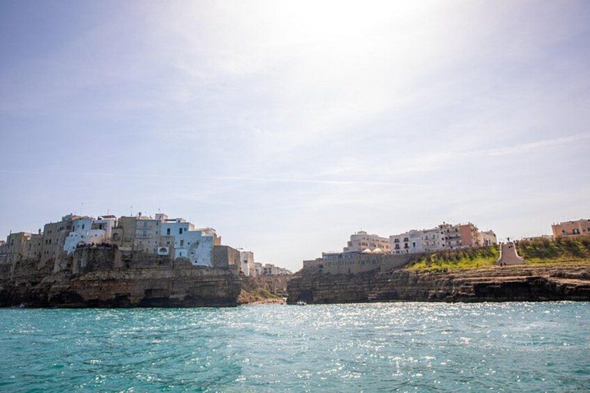 Coastal buildings on cliffs, calm sea, and clear sky. 4
