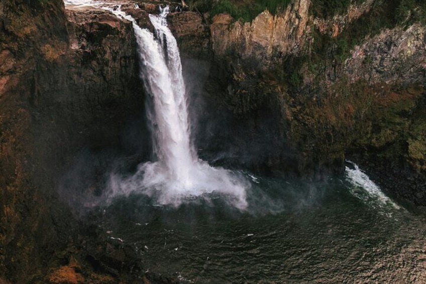 A waterfall cascading into a pool surrounded by rocky cliffs. 2