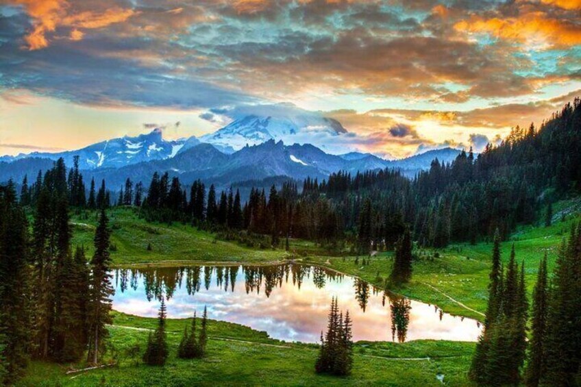 A mountain landscape with a lake surrounded by trees. 5