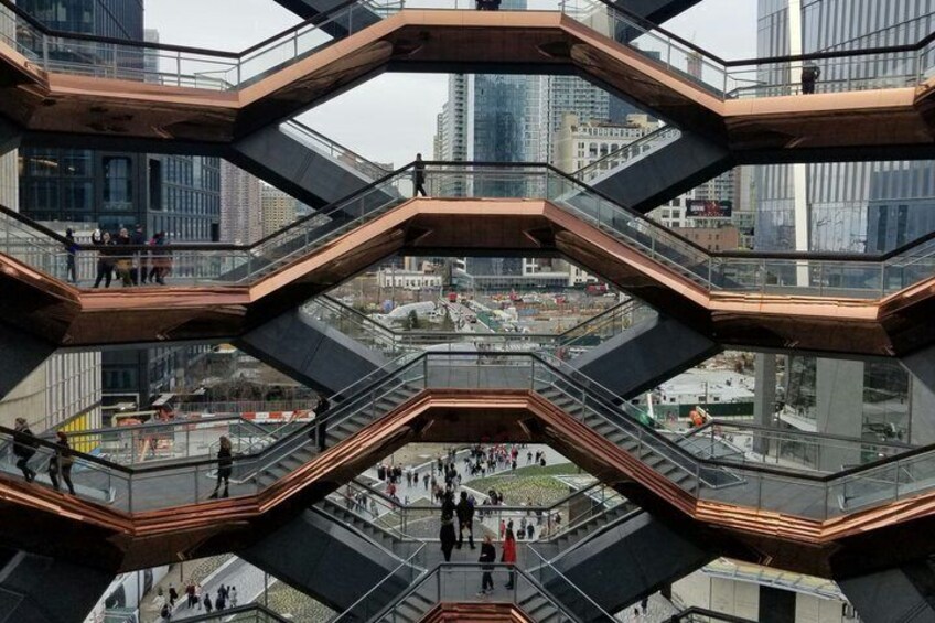 A modern architectural structure with multiple levels and glass railings. 3
