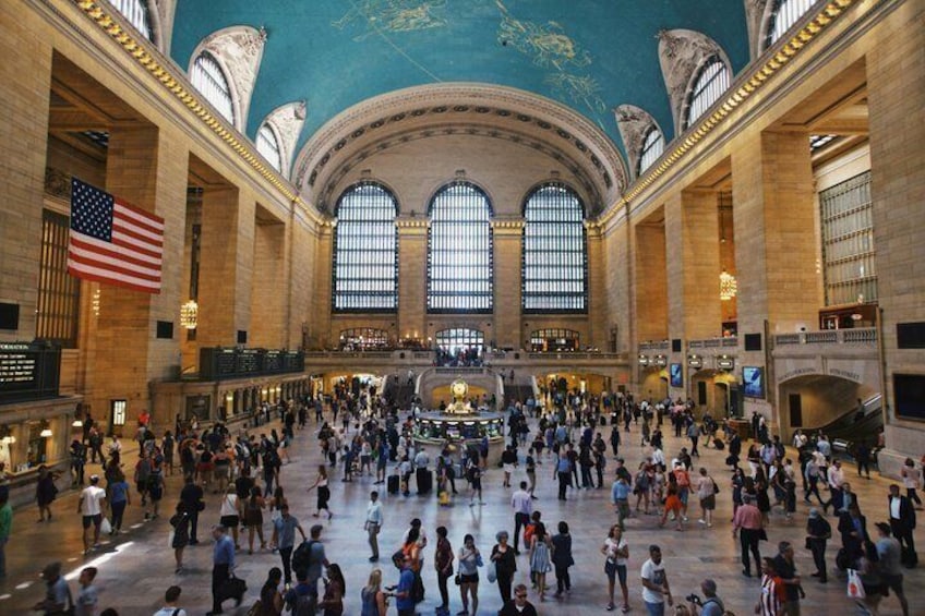 A large indoor public space with high ceilings, large windows, and a central open area. 4