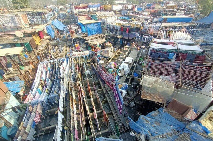 A densely packed market with numerous stalls selling textiles and fabrics. 2