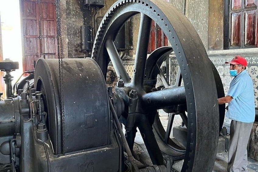 A large mechanical wheel with a person standing beside it. 3