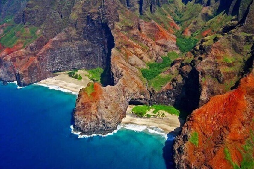 A coastal landscape with cliffs, a beach, and a small cove. 1