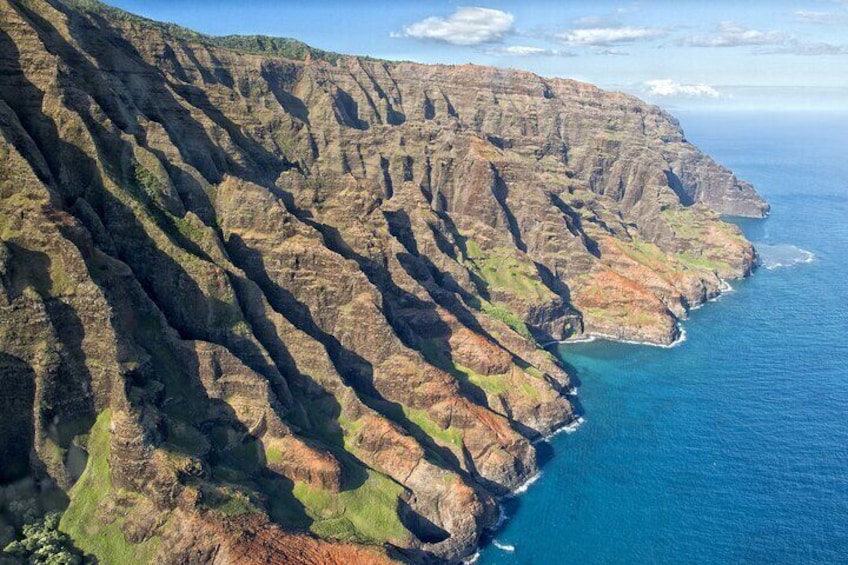 A rugged coastline with steep cliffs and a deep blue ocean. 2