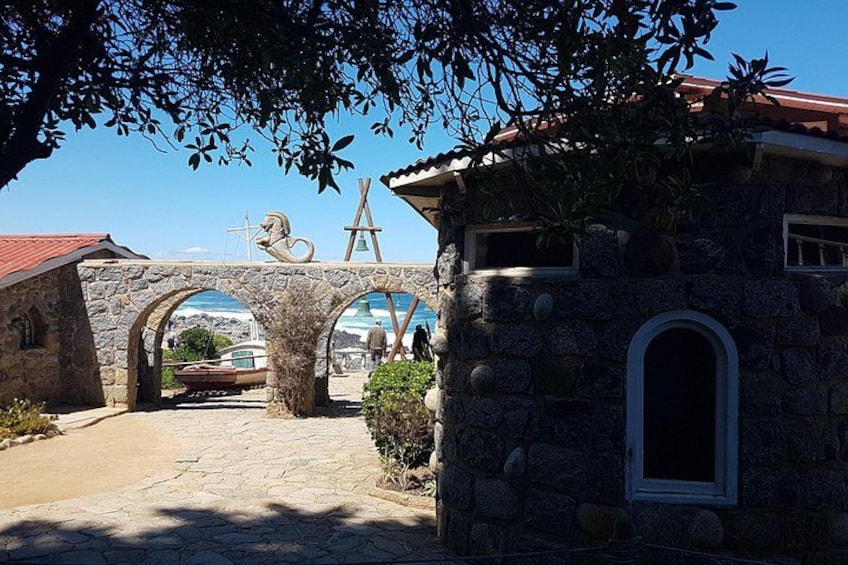 A stone bridge, a stone building, and a tree. 1