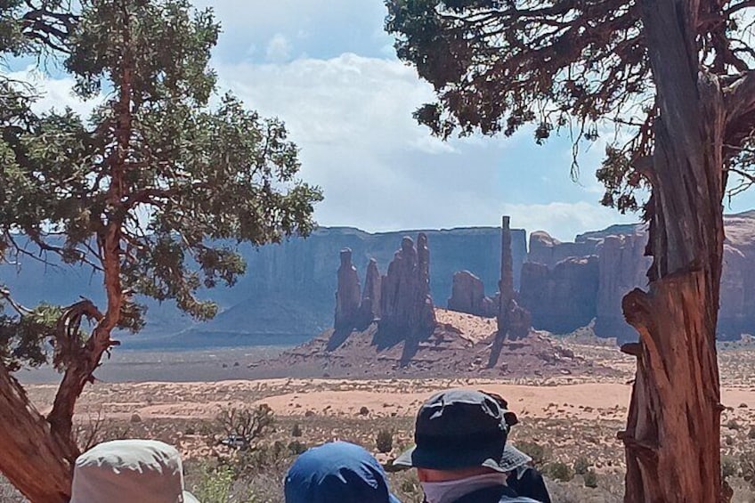 A desert landscape with prominent rock formations and a person in the foreground. 5