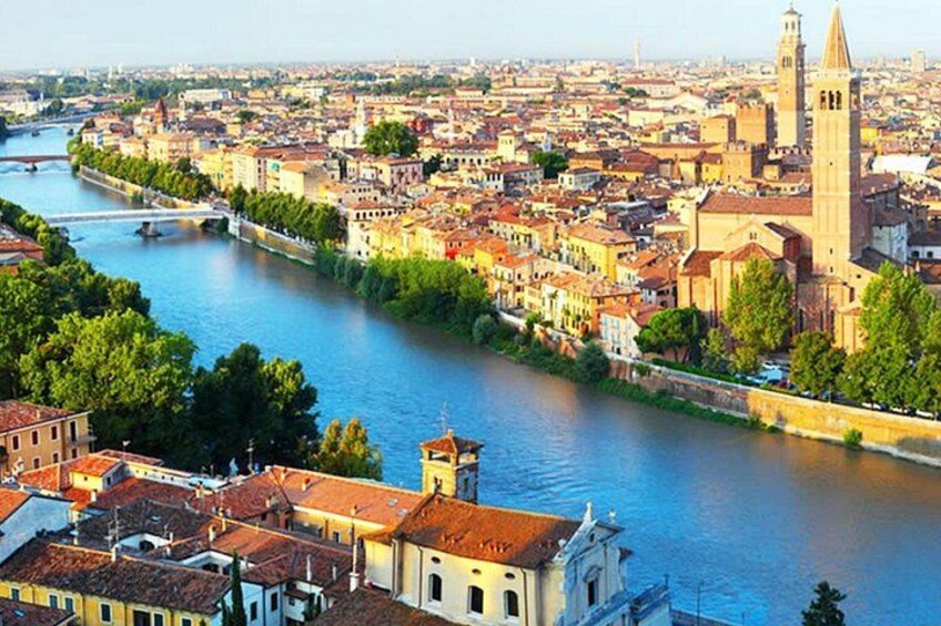 A river flowing through a city with historic buildings and a prominent church tower. 3