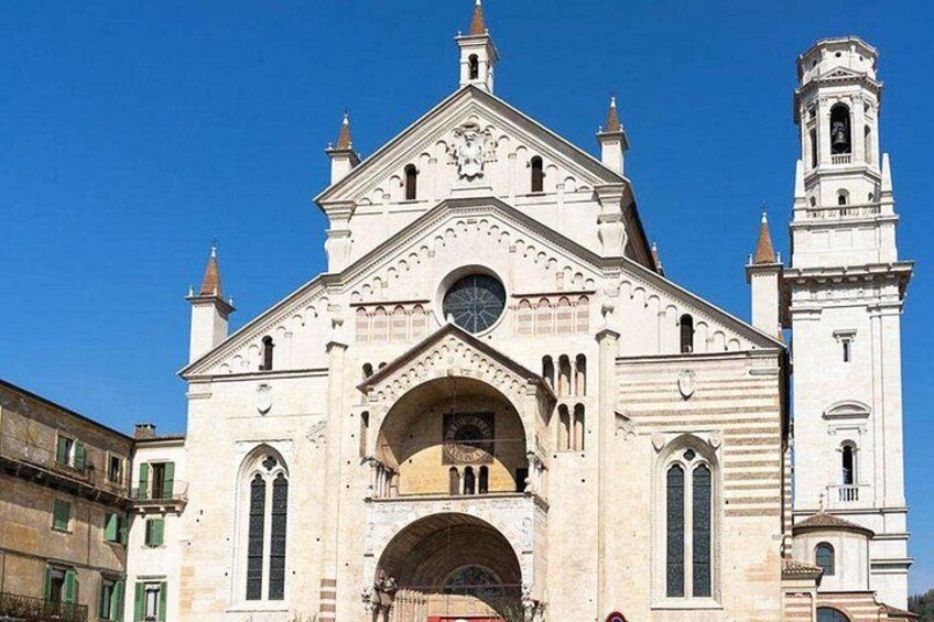 A historic church with a prominent bell tower and arched windows. 5