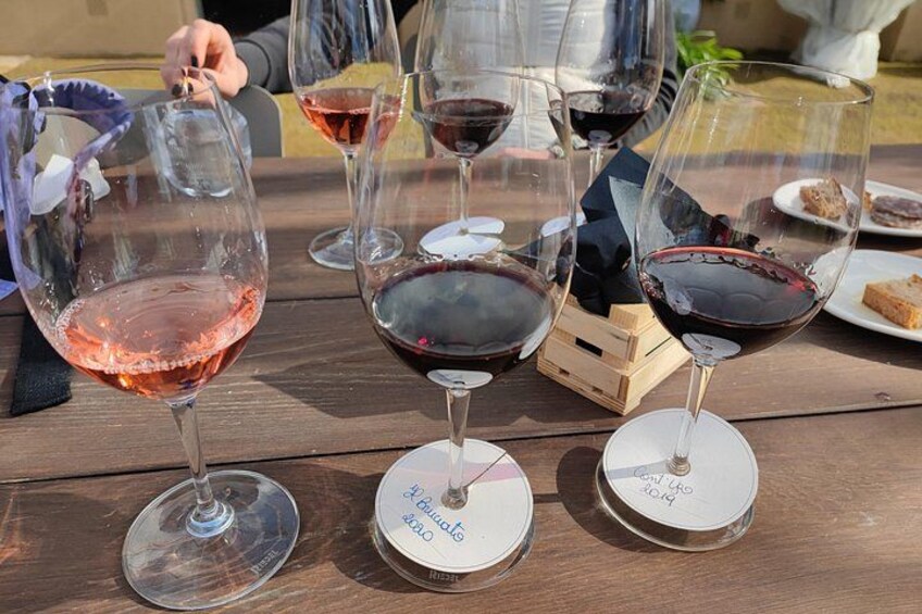 Wine glasses on a wooden table with labels. 3